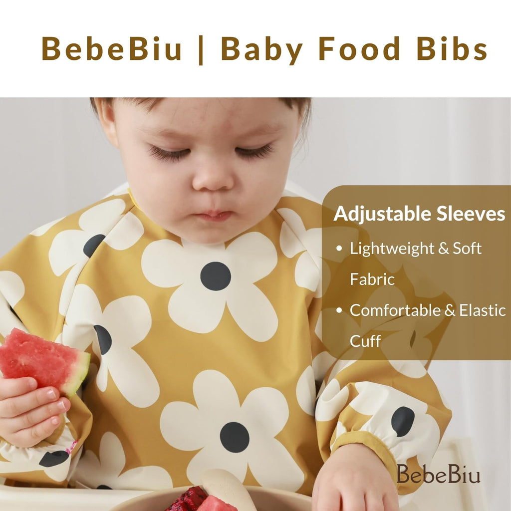 BebeBiu Long Sleeve Baby Bib, Waterproof Fabric, Full Coverage with Catch-All Pocket, Baby Smock Bib, Adjustable Sleeves Toddler bib for Ages 6-24 Months (Bows Blush, Small 6-24 Months)