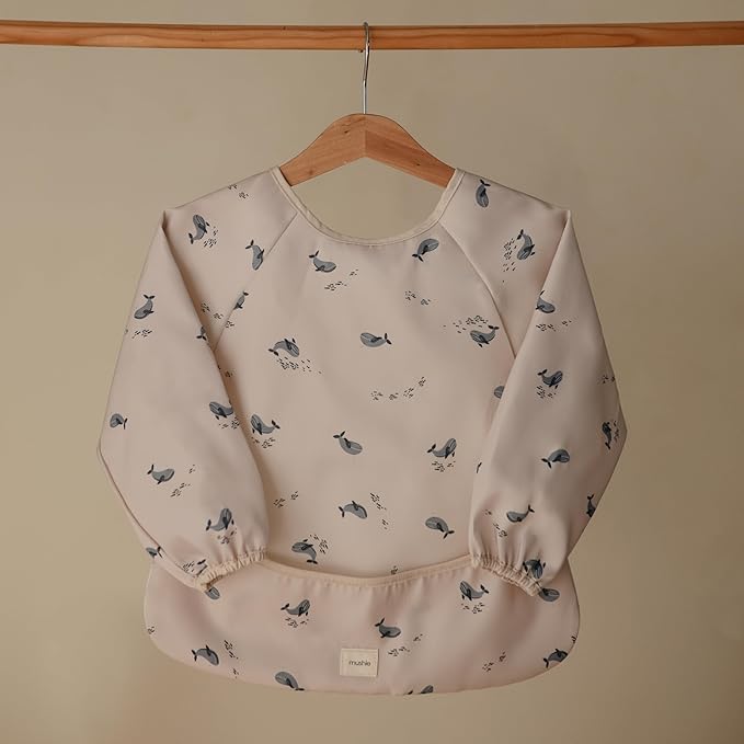 mushie Long Sleeve Baby Bib | Water Resistant Adjustable Fit for Ages 6-24 Months