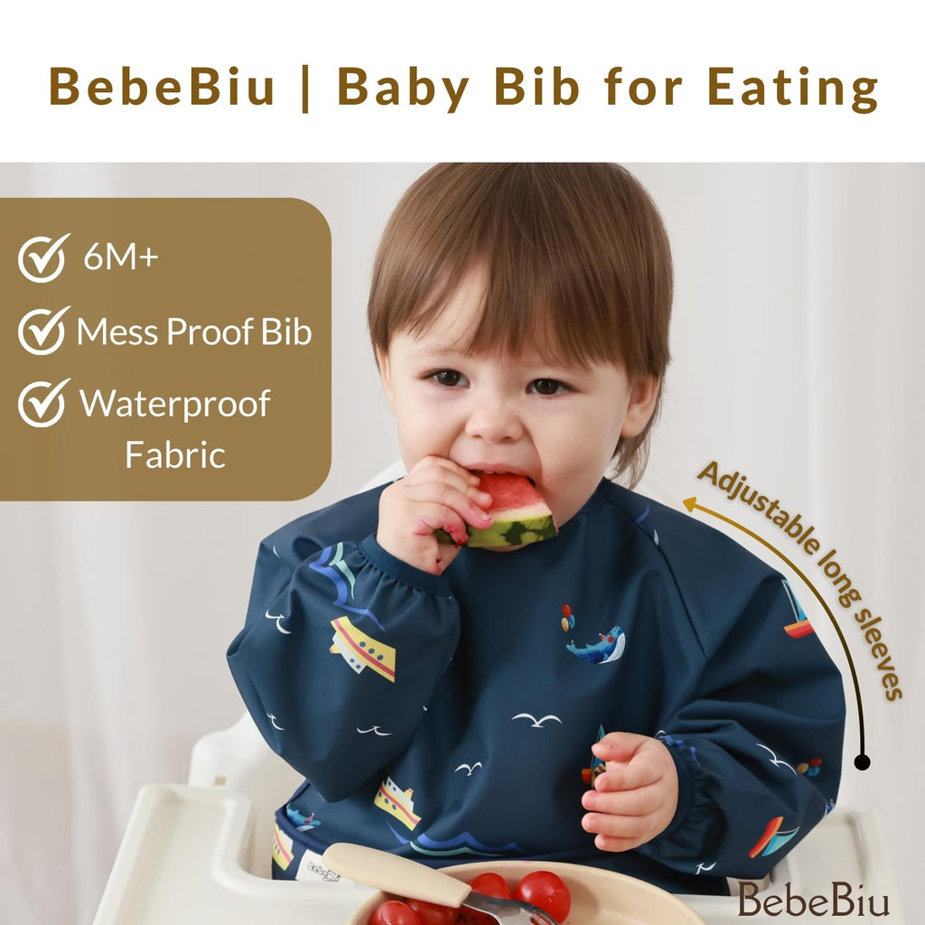 BebeBiu Long Sleeve Baby Bib, Waterproof Fabric, Full Coverage with Catch-All Pocket, Baby Smock Bib, Adjustable Sleeves Toddler bib for Ages 6-24 Months (Bows Blush, Small 6-24 Months)