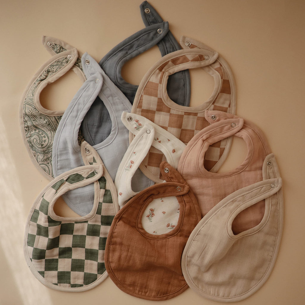 mushie Muslin Baby Bib | Soft Cotton for Infant Drips, Drools & Feedings | Adjustable Fit | 2 Pack (Green Paisley/Fog)