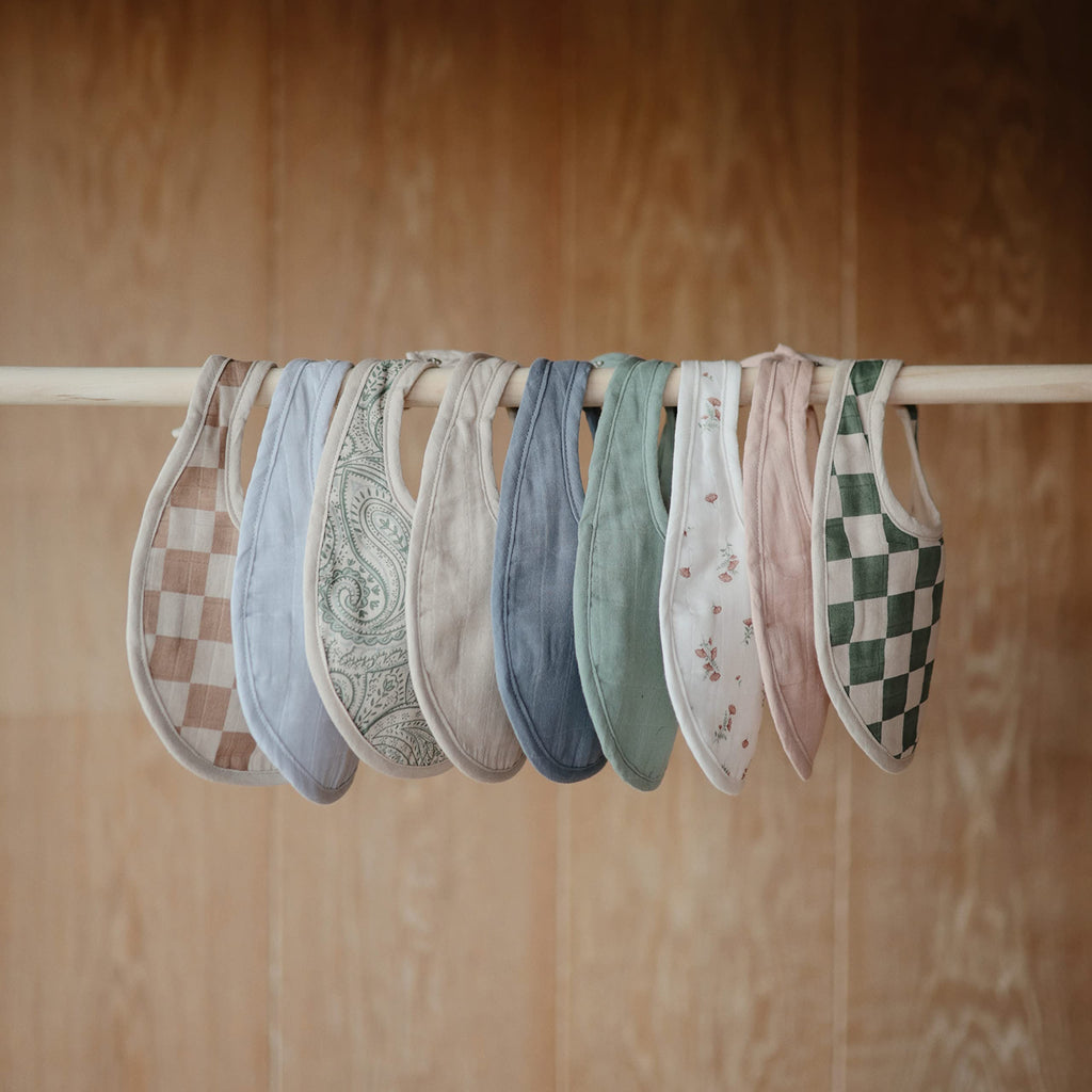 mushie Muslin Baby Bib | Soft Cotton for Infant Drips, Drools & Feedings | Adjustable Fit | 2 Pack (Green Paisley/Fog)